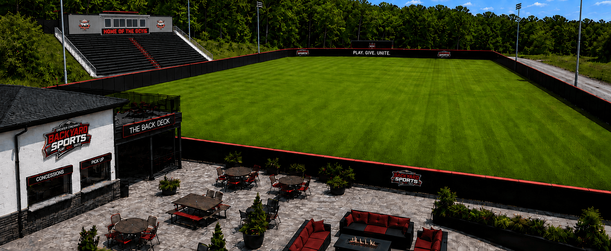 Concept rendering of the future O.W. Davis Backyard Sports Park in Dayton, Kentucky, featuring a lush green playing field, grandstand seating, padded perimeter walls, The Back Deck facility, concession patio and sports lighting — illustrative future vision